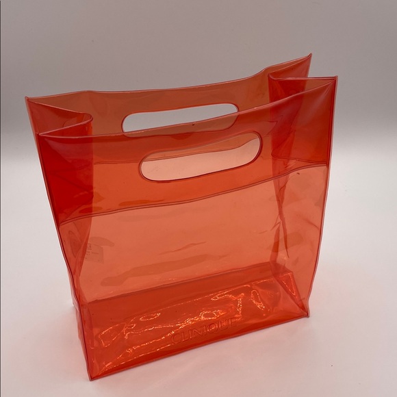 Clinique Handbags - CLINIQUE ORANGE CLEAR COSMETIC TOTE BAG PVC HANDLES